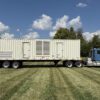 Rear view of containerized Caterpillar 3516 generator on trailer.