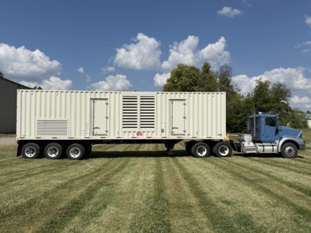 Rear view of containerized Caterpillar 3516 generator on trailer.