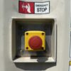 Emergency stop button mounted on generator enclosure.