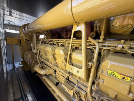 Caterpillar 3516 engine right side with valve covers and piping.