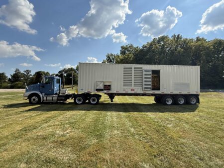 Front view of Caterpillar generator with access doors open.