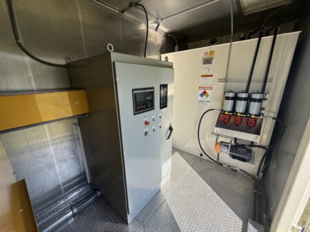 Generator control panel and fuel filtration system inside container.
