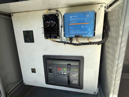Interior view of Caterpillar generator breaker and charger cabinet.