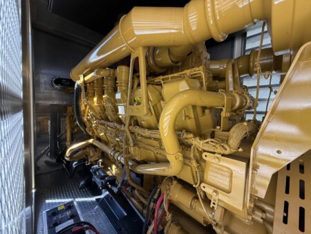 Side view of Caterpillar 3516 engine inside container.