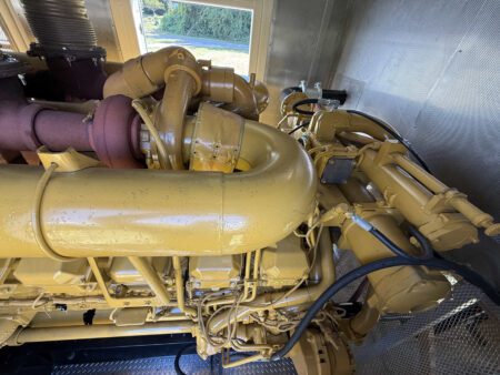 Close-up view of Caterpillar 3516 turbocharger and exhaust manifold.