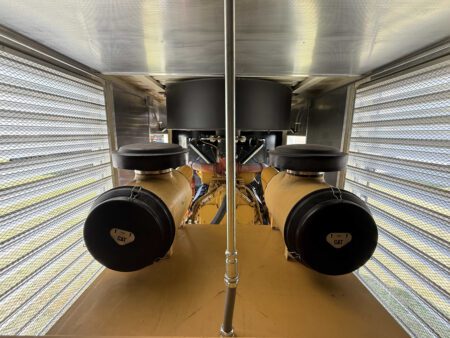 Dual Caterpillar air filters inside generator enclosure.