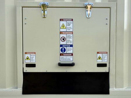 Rear service access panel with warning labels.