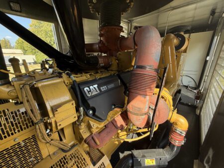 Side profile of Caterpillar C27 engine inside containerized generator.