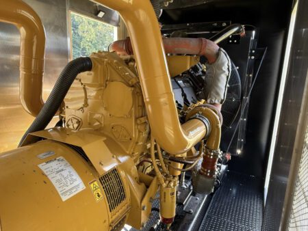 Front view of Caterpillar C27 engine with radiator and piping.