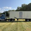 Front view of Caterpillar C27 generator container on trailer.