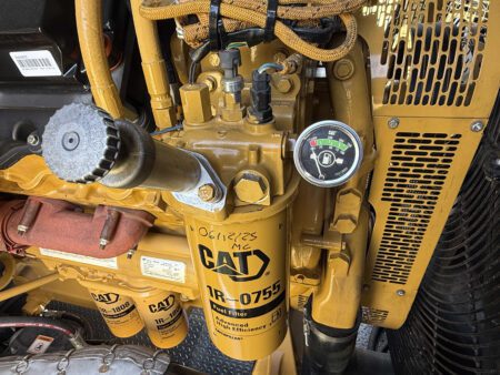 CAT fuel filter with contamination indicator gauge and water separator bowl.
