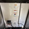 Sub-base diesel fuel day tank with warning labels and dual Racor filters.