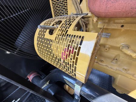 Protective alternator guard over rotating components of the generator end.