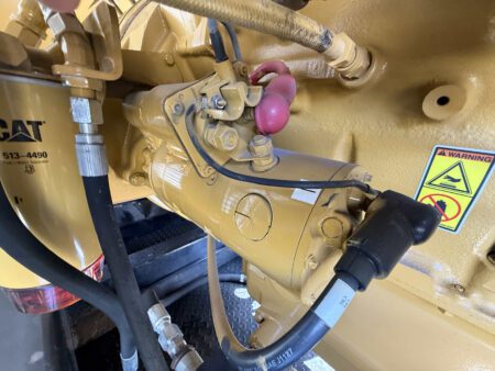 Close-up view of Caterpillar C27 starter motor assembly.