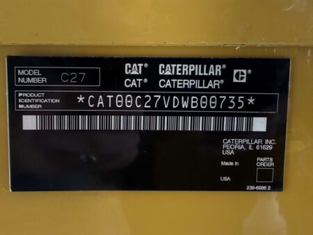 Caterpillar C27 product identification tag with model and serial number.