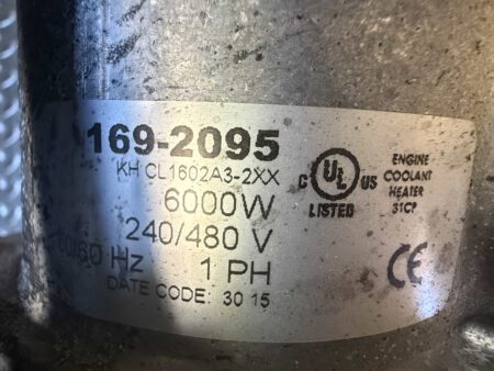 Data plate for engine coolant heater showing specifications.