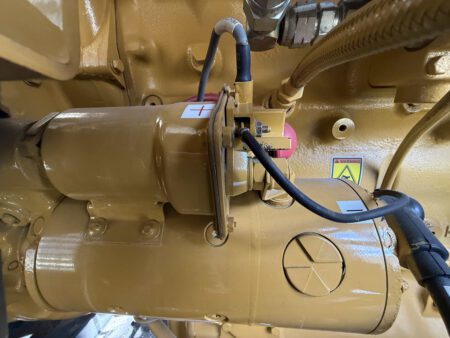 Caterpillar generator starter motor assembly and wiring connections.
