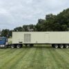 Caterpillar 3516 generator enclosure on trailer, front view with doors closed.