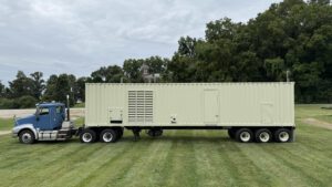 Caterpillar 3516 generator enclosure on trailer, front view with doors closed.