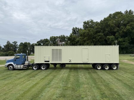 Caterpillar 3516 generator enclosure on trailer, front view with doors closed.