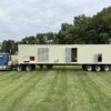 Caterpillar 3516 generator enclosure with front access doors open.