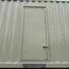 Closed personnel access door on Caterpillar generator container.
