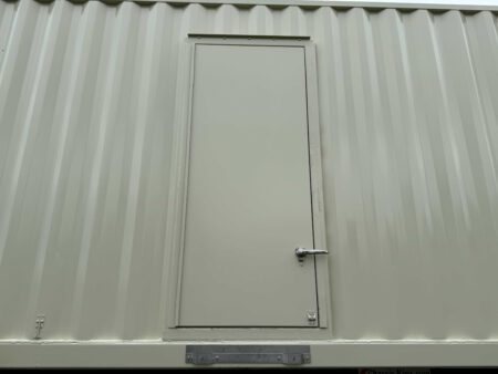 Closed personnel access door on Caterpillar generator container.