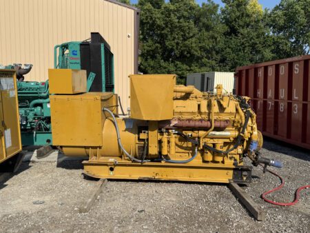 Side profile of 1988 Caterpillar 3412 600kW diesel generator showing engine, alternator, and breaker enclosure