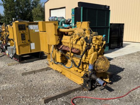 Front side angle of 1988 Caterpillar 3412 600kW diesel generator showing engine block and flywheel housing