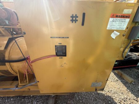 Breaker cabinet on 1988 Caterpillar 3412 600kW diesel generator with ON/OFF switch and safety label