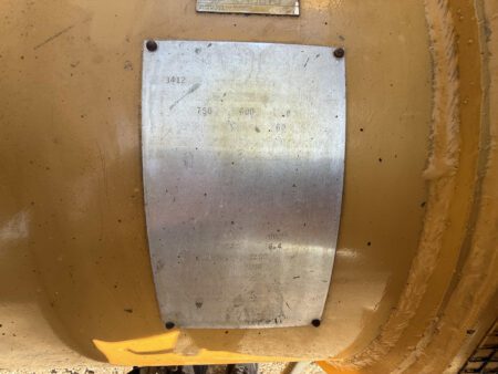 Faded Caterpillar 3412 generator spec plate mounted on housing