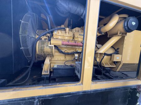Right-side bay open on 2000 CAT 3412 500 kW generator (S/N BPG00168) showing 3412 engine, cooling fan, battery bank with charger, and air-intake canister/ducting.