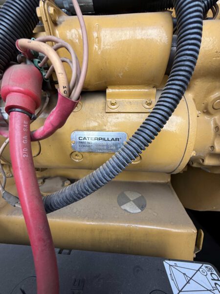 Starter motor assembly with Caterpillar part tag and heavy-gauge battery cables on 2000 CAT 3412 500 kW generator (S/N BPG00168).