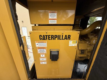 Back view of 2003 Caterpillar 3306 250kW generator showing breaker panel and warning labels.