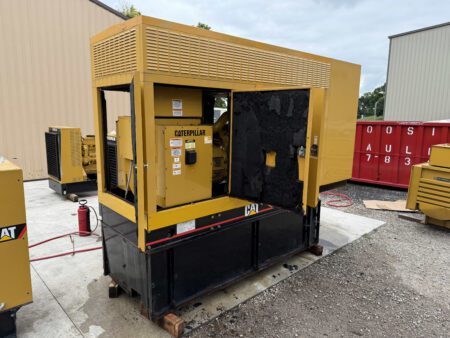 2003 Caterpillar 3306 250kW diesel generator – back left angle with enclosure doors open, showing breaker panel and insulation.