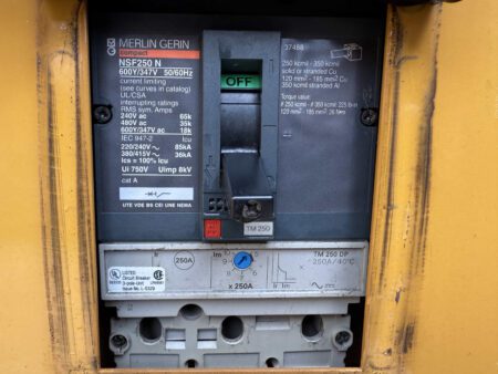 Close-up of Merlin Gerin NSF250 N 250A circuit breaker installed on a 2003 Caterpillar 3306 250kW generator.