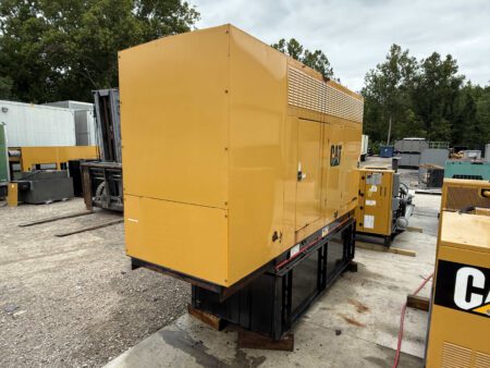 2003 Caterpillar 3306 250kW generator, front-left side view with enclosure closed, mounted on a black sub-base fuel tank outdoors.