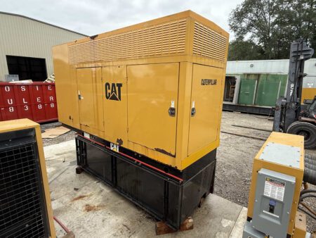 2003 Caterpillar 3306 250kW generator, front-right exterior view with enclosure doors closed, CAT logo visible, mounted on black sub-base fuel tank outdoors.