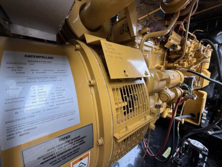 Side view of 2003 Caterpillar 3306 250kW generator showing generator data plate and engine components.