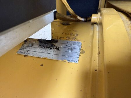 Caterpillar generator end data plate on 2003 CAT 3306 250kW diesel generator, showing arrangement number and compliance details.