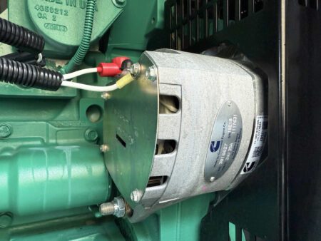 Close-up of the Cummins generator’s 24V Delco Remy alternator mounted on the QSX15 engine.