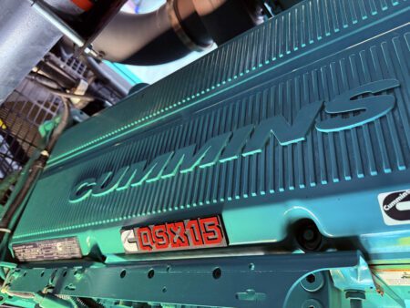 Cummins QSX15 diesel engine block inside generator enclosure.