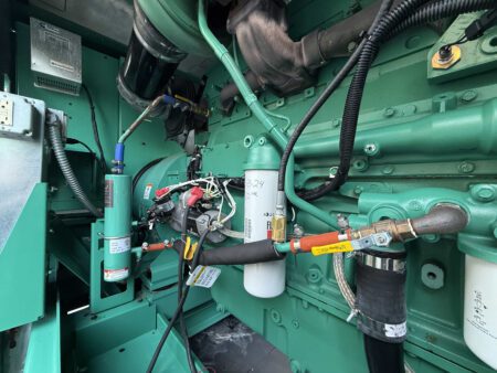 Cummins QSX15 engine compartment showing starter, filters, and wiring in a 2018 DFEK 500kW genset.