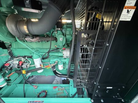 Side view of Cummins QSX15 engine with radiator guard and coolant piping inside 2018 Cummins DFEK 500kW generator set.