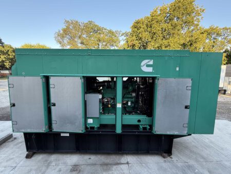 Front view of 2018 Cummins DFEK 500kW diesel generator with enclosure doors open to show engine.