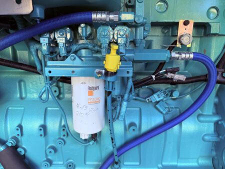 Fleetguard FS1040 fuel filter mounted on Cummins QSX15 engine.