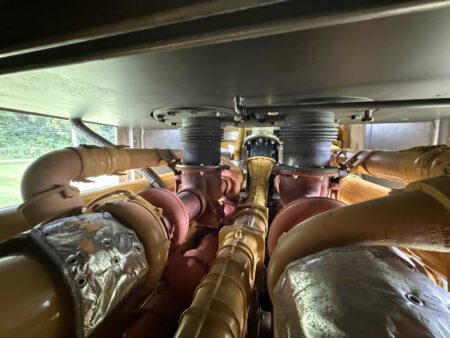 Turbocharger section of Caterpillar 3516C diesel generator engine showing dual turbochargers and exhaust piping.
