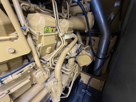 Close-up of Caterpillar 3516C diesel generator engine cylinder head and fuel system assembly.