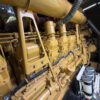 Caterpillar 3516C diesel generator engine block side view showing cylinder banks and fuel system components.