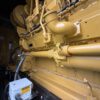 Caterpillar 3516C diesel generator crankcase and oil passage area with cylinder bank covers.